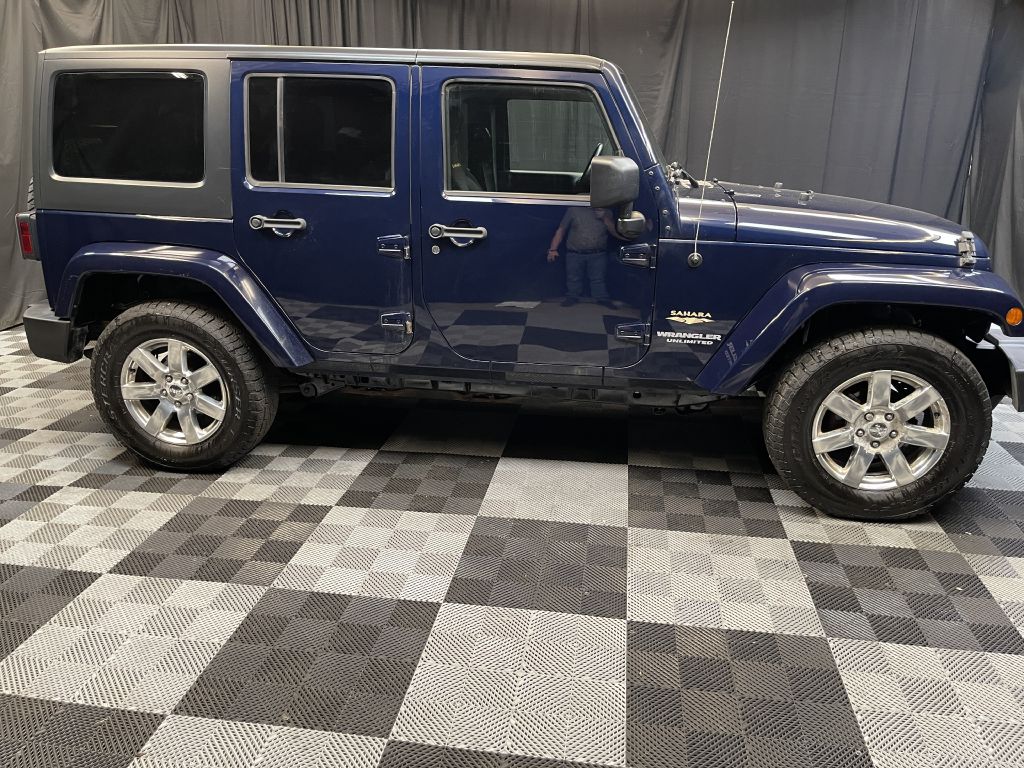 2013 JEEP WRANGLER UNLIMI SAHARA for sale at Solid Rock Auto Group